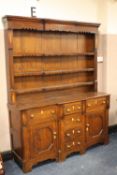 A 19TH CENTURY OAK WELSH DRESSER, the plate rack with shaped frilled frieze and shelves,with