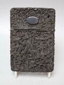 A CHINESE CARVED TORTOISESHELL CARD CASE, typically carved with figures and pavilions, 12 x 8 cm A/