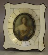 BAUER (XX). An oval portrait miniature on ivorine of a young woman in elegant dress, signed middle
