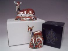 A ROYAL CROWN DERBY COLLECTORS GUILD 'DEER' PAPERWEIGHT, together with a 'Fawn' paperweight, both