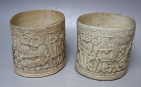 A NEAR PAIR OF 19TH CENTURY CHINESE CARVED IVORY TUSK SLEEVES, each with carved figures and