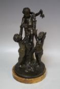 A 19TH CENTURY BRONZE FIGURATIVE STUDY OF THREE CHERUBS ON AND AROUND A TREE STUMP, raised on a