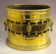A LARGE ANTIQUE BRASS OVAL COAL BIN, pierced gallery, twin lion head ring turned handles, with