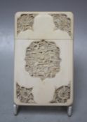A CIRCA 1900 CHINESE CANTON IVORY CARD CASE, having shaped and relief carved opposing panelled