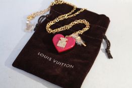LOUIS VUITTON - A RESIN 'LOCK ME' HEART PENDANT NECKLACE, pendant drop 2.5 cm, chain L 55 cm, with