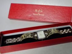 A BOXED KENNETH JAY LANE ANIMAL PRINT WATCH, silver tone with crystal embellishment