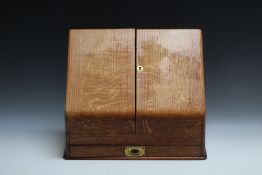 AN OAK SLOPE FRONTED STATIONARY BOX, W 37 cm