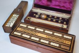 A MAHOGANY CASED GAMES COMPENDIUM, cased hydrometer and a cased set of dominoes (3)
