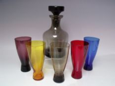 A STUDIO GLASS DECANTER WITH FIVE SHAPED HARLEQUIN TUMBLERS, together with a selection of studio