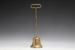 A BRASS DOOR STOP IN THE FORM OF A BELL, H 37 cm