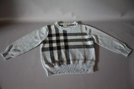 A CHILDS VINTAGE BURBERRY JUMPER, pale blue with traditional Burberry design