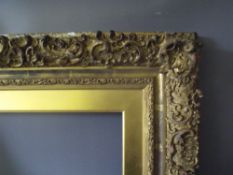A 19TH CENTURY DECORATIVE GOLD FRAME WITH GOLD SLIP A/F, frame W 10 cm, frame rebate 58 x 43 cm,