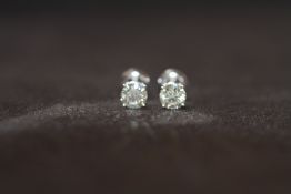 A PAIR OF 18ct WHITE GOLD SCREW BACK SOLITAIRE DIAMOND STUDS, boxed. Diamonds 1.14ct approx