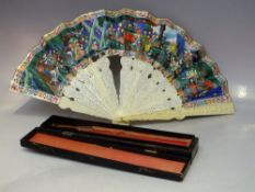 AN ANTIQUE ORIENTAL CARVED IVORY DECORATIVE FOLDING FAN, with profuse carving to both the guards and