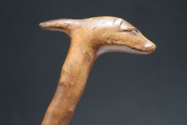 A WALKING STICK WITH A CARVED DOG HEAD HANDLE, L 89 cm