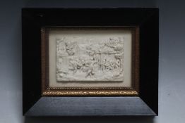 A FRAMED CARVED PLAQUE OF REVELLERS DRINKING OUTSIDE A TAVERN, W 18 cm