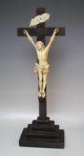 A EUROPEAN CARVED IVORY CORPUS CHRISTI ON AND EBONY CROSS, bearing ivory 'INRI' plaque to the top, H