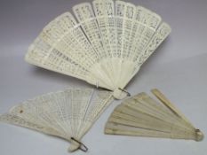 TWO ANTIQUE CARVED BONE / IVORY BRISE FANS FOR RESTORATION, longest L 26 cm, together with a plain