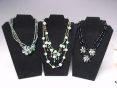 A SELECTION OF BUTLER AND WILSON FASHION NECKLACES, to include a gold tone triple strand aurora