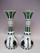 A PAIR OF BOHEMIAN GREEN GLASS AND WHITE ENAMEL OVERLAY VASES, with gilt decoration, H 32 cm