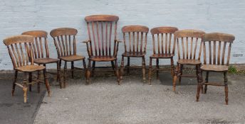 A HARLEQUIN SET OF EIGHT ANTIQUE TRADITIONAL WINDSOR KITCHEN CHAIRS TO INCLUDE AN ARMCHAIR, each