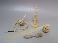 AN ANTIQUE IVORY SPINNING DICE, together with a collection of ivory items to include a carved