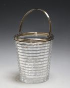 A HALLMARKED SILVER AND EDINBURGH CRYSTAL SWING HANDLED ICE BUCKET BY GOLDSMITHS AND SILVERSMITHS CO