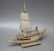 A LATE 19TH / EARLY 20TH CENTURY IVORY CARVED JUNK WITH FISHERMAN, raised on a rectangular plinth