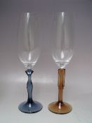 A BOXED SET OF KOSTA BODA CHAMPAGNE GLASSES 'TWO OF US' DESIGNED BY KJELL ENGMAN, together with a