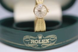 ROLEX - A LADIES 18 CARAT GOLD WRIST WATCH, in heart shaped green Rolex box with original