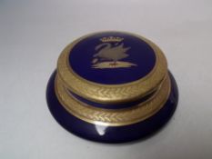 A CONTINENTAL CIRCULAR CERAMIC LIDDED POT, blue ground, with gilded border, armorial style crest