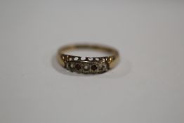 A HALLMARKED 9 CARAT GOLD FIVE STONE RING