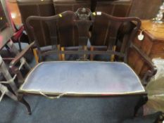 AN EDWARDIAN EBONISED TWO SEATER SOFA