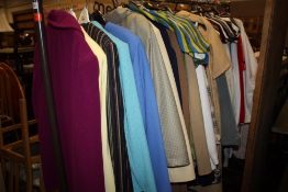 A RAIL OF VINTAGE AND MODERN LADIES CLOTHING