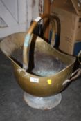 A BRASS HELMET SHAPED COAL BUCKET
