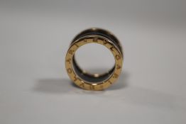 A BVLGARI 18CT ROSE GOLD FOUR BAND RING, the ring with black sprung ceramic spiral design to the