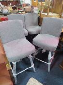 A SET OF FOUR MODERN UPHOLSTERED SWIVEL BAR STOOLS