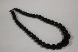A CARVED WHITBY JET BEADED NECKLACE