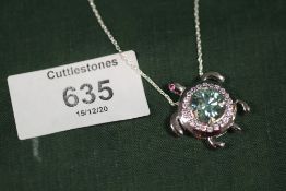 A STERLING SILVER AND BLUE MOISSANITE PENDANT ON CHAIN