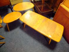 AN ERCOL STYLE LOW COFFEE TABLE, L-105 CM AND TWO 'PEBBLES' OCCASIONAL TABLES (3)