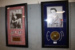 A FRAMED AND GLAZED PICTURE OF ELVIS CONTAINING A FRAGMENT OF HAIR TOGETHER WITH A MARILYN MONROE