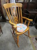 A MODERN LIGHT COLOURED ROCKING CHAIR