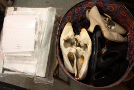 A VINTAGE LEATHER HAT BOX CONTAINING VINTAGE SHOES TOGETHER WITH A COLLECTION OF TABLECLOTHS