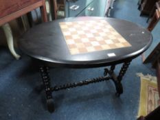 AN EDWARDIAN EBONISED GAMES TABLE
