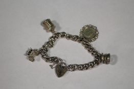 A HALLMARKED SILVER CHARM BRACELET