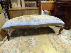 AN UNUSUAL ANTIQUE MAHOGANY SHAPED LONG STOOL WITH BEADED UPHOLSTERY DETAIL, ON ORIENTAL CAPPINGS