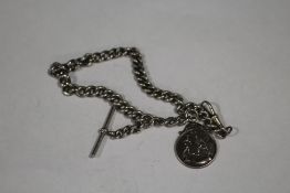 AN ANTIQUE SILVER POCKET WATCH CHAIN WITH SILVER FOOTBALL INTEREST FOB