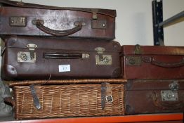 A COLLECTION OF VINTAGE BRIEFCASES TOGETHER WITH A WICKER BASKET