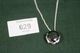 A MODERN STERLING SILVER AND BLACK DIAMOND STYLE PENDANT ON CHAIN