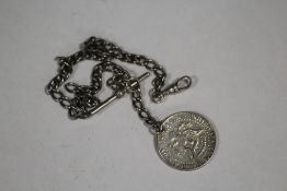 AN ANTIQUE SILVER ALBERT CHAIN WITH HALF DOLLAR COIN FOB